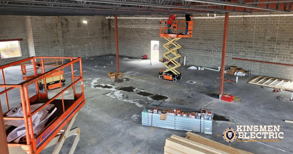 Commercial electrical installation at BFS Somerset convenience store under construction, with crews, tools, and building materials.