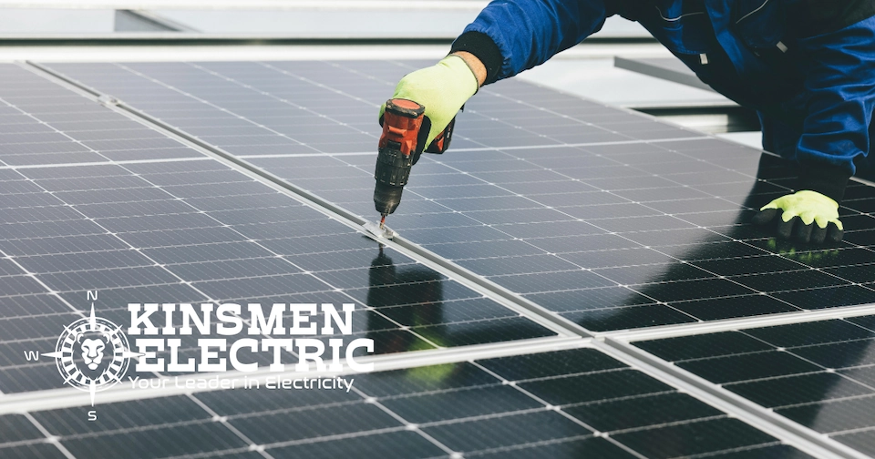 an electrical expert uses a screwdriver to tighten solar panels on a roof