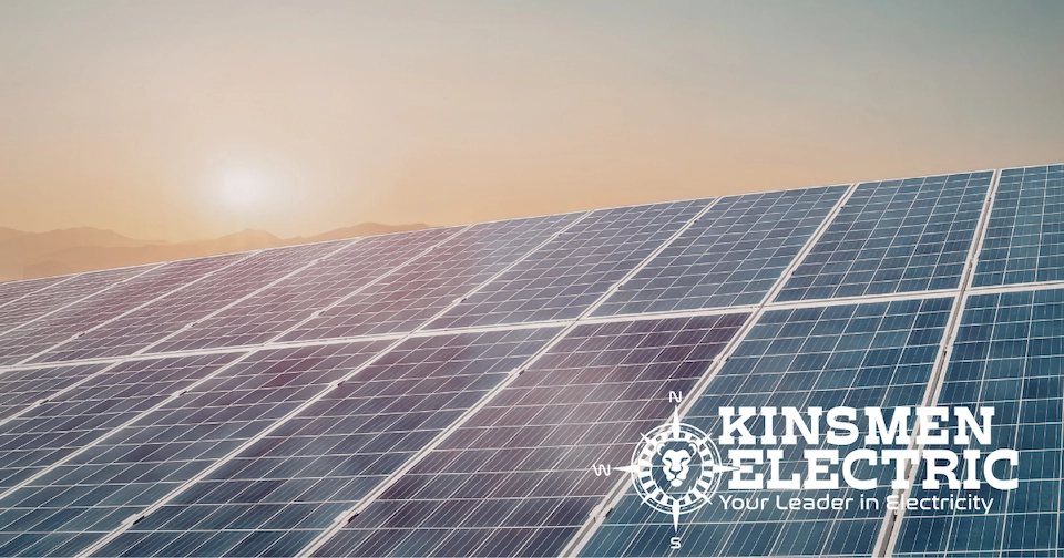 a solar panel with the sun rising in the background