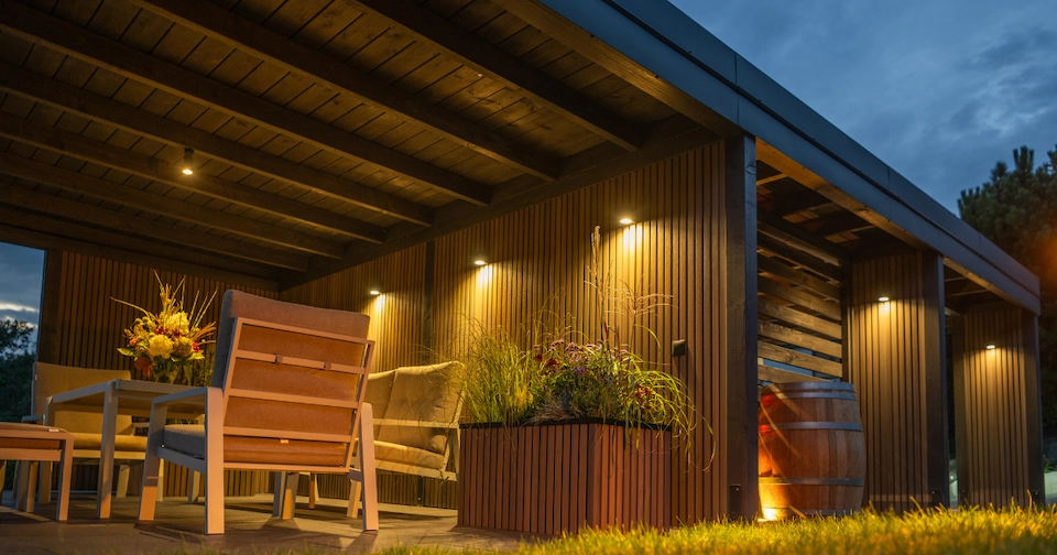 an evening picture of a warm and cozy outdoor space at a home that is well-lit
