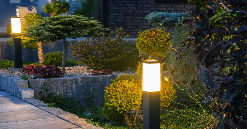 a pathway lined with outdoor landscape lighting