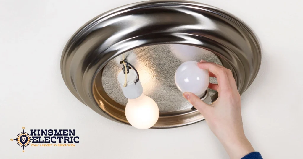 someone changing lightbulbs in a ceiling light