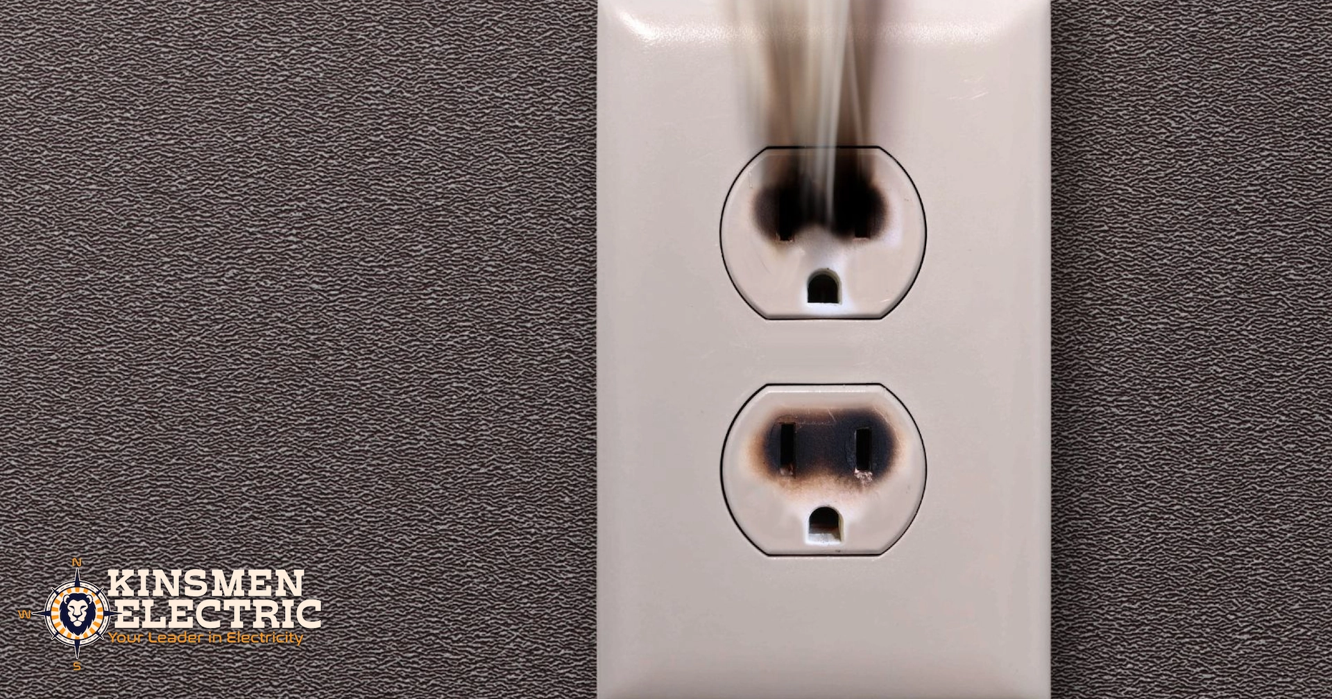 close-up of a smoking electrical outlet with burn marks, suggesting an electrical inspection is needed urgently.